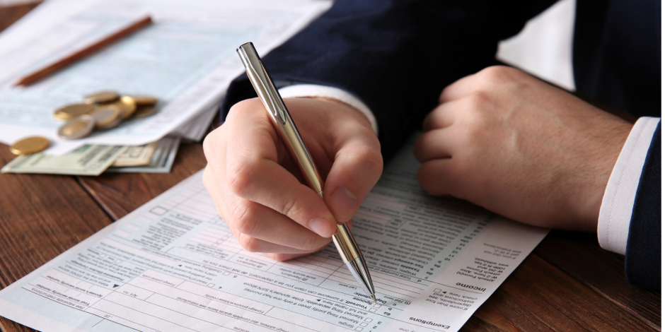 Man filling out a form with a pen